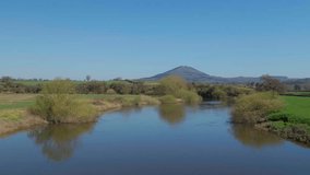 A panning shot over the River Severn in Cressage, Shropshire, looking towards the Wrekin Hill, a local landmark