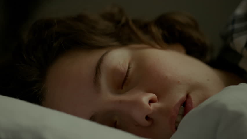 Portrait of a young woman who sleeps wakes up early in the morning from the sound of an alarm clock. The girl lies in bed does not want to get up she is tired and depressed. Sleepy woman waking up
 Royalty-Free Stock Footage #1102262141