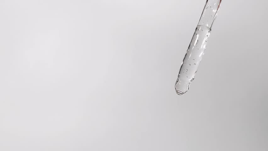 Cosmetics Drops Falls from Pipette Close-up View on a White Background, 4k, copy cpace Royalty-Free Stock Footage #1102275745