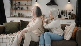 Health, body muscles stiff problem of senior couple, caucasians mature, adult retired husband, wife pain with back pain ache holding massaging rubbing shoulder hurt or sore, painful sitting on sofa. - Powered by Shutterstock - Get 15% off with code: PIKWIZARD15