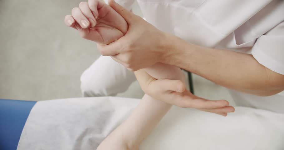 Physiotherapist treating wrist, shoulder and back of patient examined in hospital, Healthcare Concept in the professional clinic, hand exercises and physical therapy. Professional rehabilitation Royalty-Free Stock Footage #1102281089