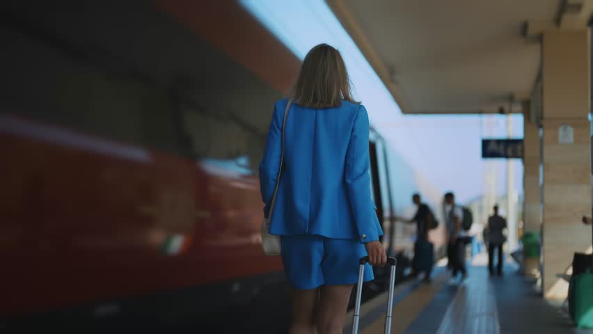 Woman walks along the platform at the train station. Royalty-Free Stock Footage #1102281381