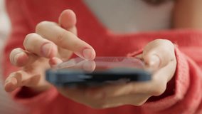 Cinematic close up shot of finger of woman touching screen of modern smartphone. Girl scrolling pages in mobile app on cell phone device. Browsing movie video on internet library to watch film online - Powered by Shutterstock - Get 15% off with code: PIKWIZARD15