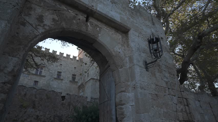 Shot through gate to reveal Palace of the Grand Master of the Knights of Rhodes, UNESCO World Heritage Site, Rhodes Town, Rhodes, Dodecanese Islands, Greek Islands, Greece, Europe