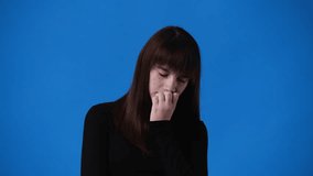 4k video of one girl doubts over blue background.