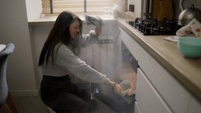 Long haired woman opening smoke filled oven in the kitchen - Powered by Shutterstock - Get 15% off with code: PIKWIZARD15