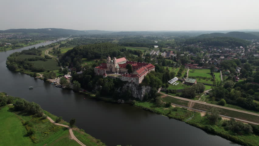 Aerial view of Benedictine abbey on the rocky hill and cliff at Vistula River on a sunny day. Tyniec, Poland.