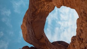 Vertical 4k Time Lapse, Clouds Moving Above Natural Arch and Red Sandstone Rock Formations. Arches National Park, Utah USA - Powered by Shutterstock - Get 15% off with code: PIKWIZARD15