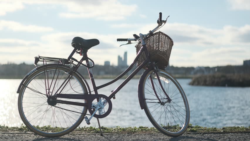 Stationary shot of a dutch bike with a reservoir in the background