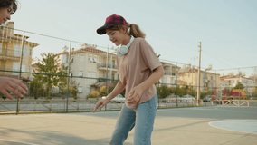 Two girls playing street basketball. Teenage school children play basketball on street basketball court in city - Powered by Shutterstock - Get 15% off with code: PIKWIZARD15