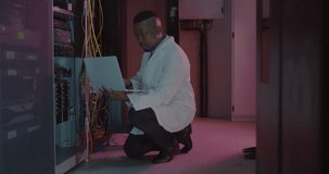 Animation of ai text and male african american it engineer and computer servers. Global connections, digital interface, cloud computing and data processing concept digitally generated video.