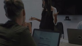 Animation of stock market data processing over biracial woman giving a presentation at office. Global economy and business technology concept - Powered by Shutterstock - Get 15% off with code: PIKWIZARD15