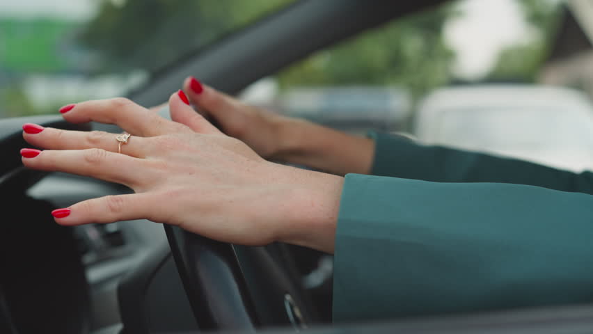 Angry woman hits steering wheel of personal automobile with hands against biker passing by. Impatient driver stuck in traffic jam closeup slow motion Royalty-Free Stock Footage #1102292787
