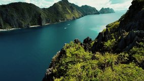4k Drone Passes Karst Cliffs to Boat in Tapiutan Island Palawan Philippines