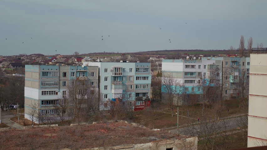 Large view of town with block of flats post communist. Depressive post USSR district communism era social housing. Royalty-Free Stock Footage #1102296563