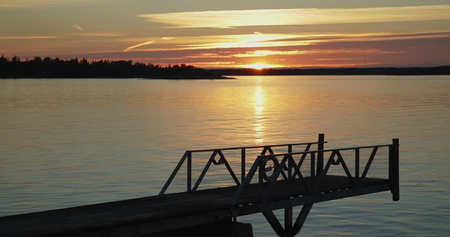 Autumn sunset at seaside with pier on the island of Torra Lövö, Espoo, Finland.