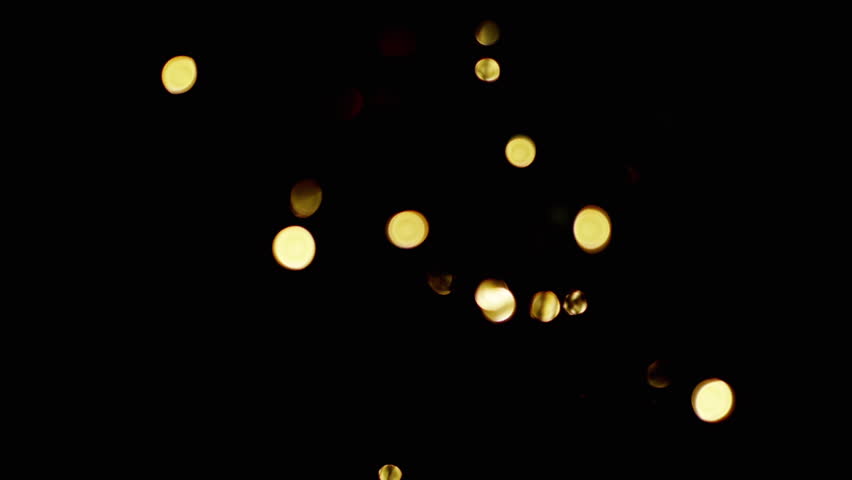 Flickering Christmas Light Bulbs, Toys on a blurred Christmas Tree Background. Unfocused abstract background with blinking golden light bulbs, and garland. Blurred bokeh. Christmas decoration. Xmas. | Shutterstock HD Video #1102298913
