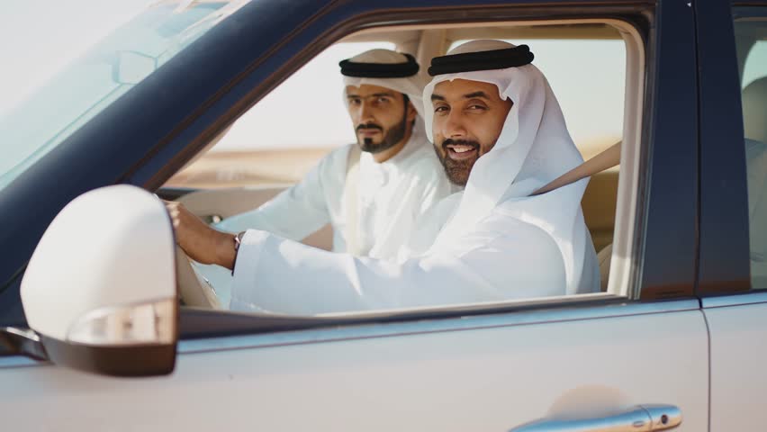 Two friends making the safari in the Dubai desert. Locals with kandura white outfit spending time together with the 4x4 car on the dunes in sharjah. Concept about traveling in the united arab emirates Royalty-Free Stock Footage #1102300897