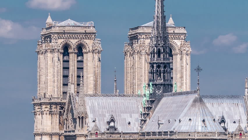 Paris with Cite Island and Cathedral Notre Dame de Paris on the background timelapse from the Arab World Institute observation deck. Top view. Green trees, Blue cloudy sky at summer day. France.