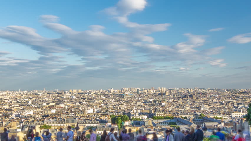 Tourists watching Paris panorama from Montmartre timelapse. Aerial view of the city from hill viewpoint. Sunset time. Blue cloudy sky at summer evening