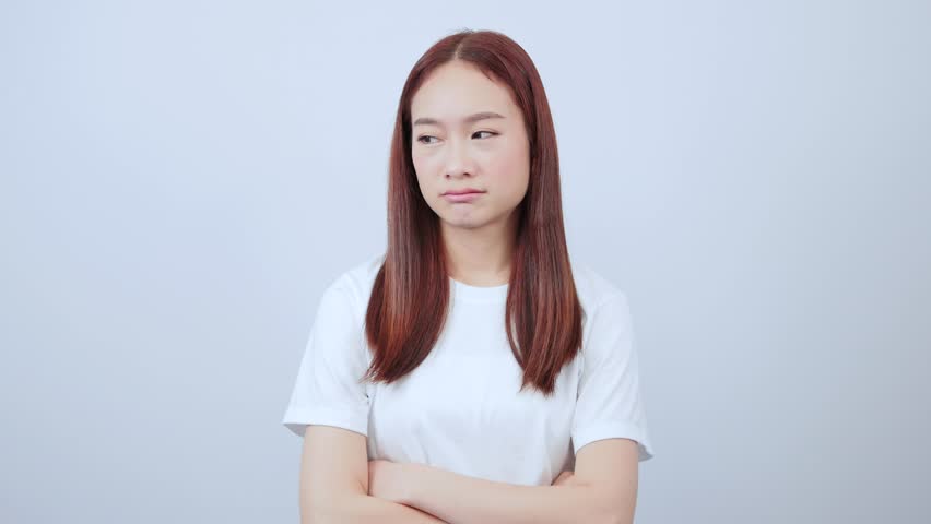 Woman pinching her nose because of bad smell in casual clothes and looks disgusting in white background. Royalty-Free Stock Footage #1102303281