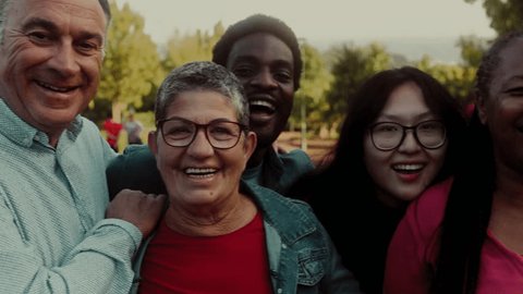 Стоковое видео: Happy multigenerational people with different ethnicity having fun smiling into the camera - Diversity concept 