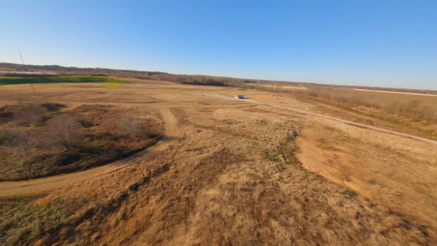 Aerial Forward Shot Of Structure On Brown Tranquil Landscape Against Clear Sky During Sunny Day - Tuscaloosa, Alabama