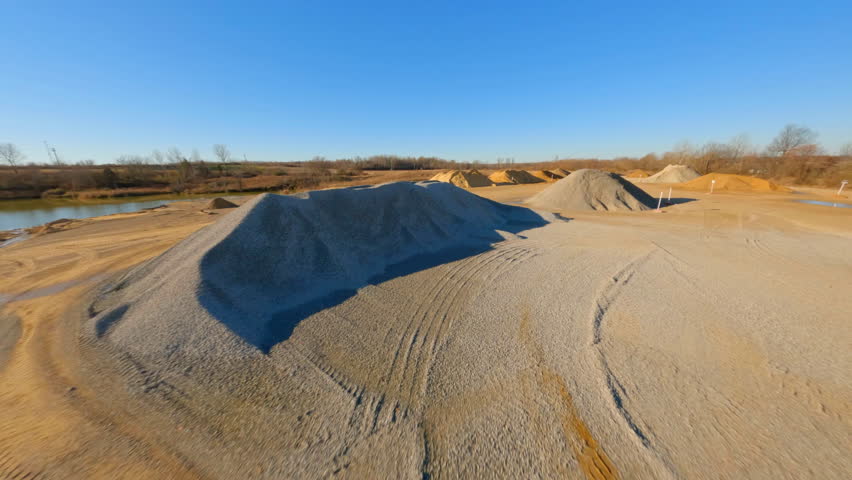 Aerial: Drone Forward Shot Of Sand And Concrete Dunes Against Clear Sky - Tuscaloosa, Alabama