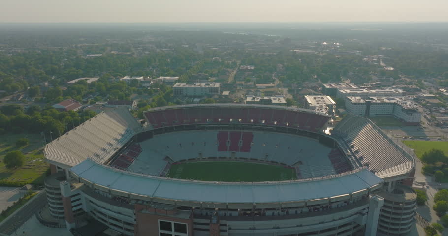 Aerial Shot Of Bryant-Denny Stadium In Residential City, Drone Flying Backwards On Sunny Day - Tuscaloosa, Alabama