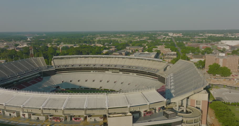 Aerial Panning Shot Of Bryant-Denny Stadium In Residential City On Sunny Day - Tuscaloosa, Alabama
