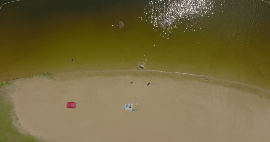 Aerial Top Shot Of Playful People On Riverside At Beach During Sunny Day - Tuscaloosa, Alabama