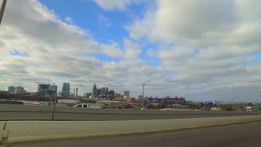 Pov Shot Of Cars Moving On Highway By City With Modern Buildings Against Cloudy Sky - Nashville, Tennessee