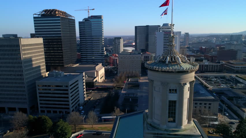 Aerial Panning Shot Of National Flags On State Government Office In Modern Office During Sunny Day - Nashville, Tennessee