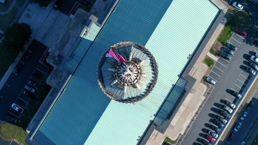 Aerial Top Panning Shot Of National Flags Waving On Tennessee State Government During Sunny Day - Nashville, Tennessee