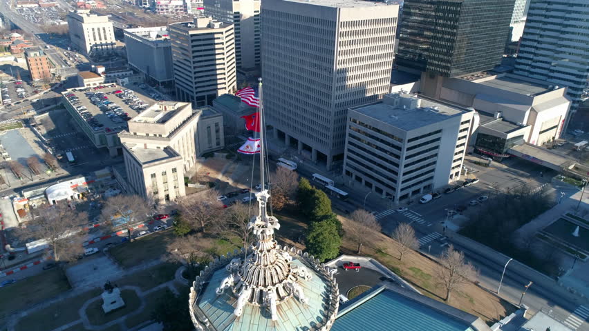 Aerial Tilt Down Shot Of National Flags On Tennessee State Capitol In Downtown Drone Flying Upwards During Sunny Day - Nashville, Tennessee