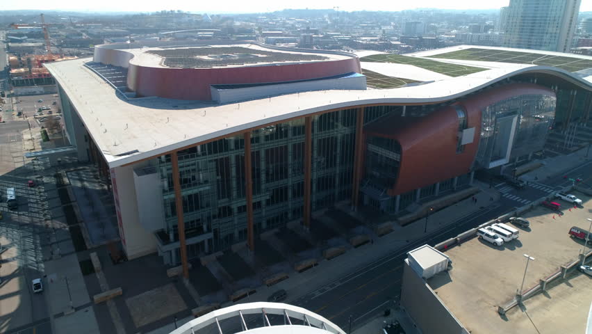 Aerial Shot Of Music City Center By Cars Moving On Road, Drone Flying Forward During Sunny Day - Nashville, Tennessee