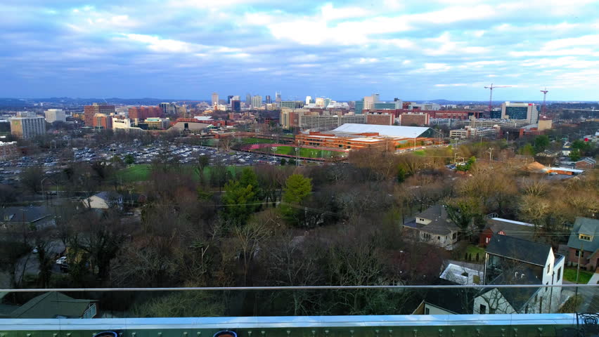 Aerial Backward Shot Of Modern Buildings By Cars On Roads Under Sky In City - Nashville, Tennessee