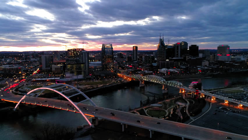 Aerial Shot Of Vehicles Moving On Korean Veterans Memorial Bridge, Drone Flying Forward Over City During Dusk - Nashville, Tennessee Royalty-Free Stock Footage #1102310511