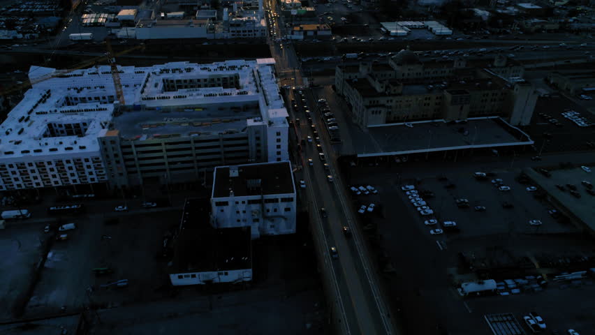 Aerial Forward Tilt Up Shot Of Cars Moving On Roads In Modern City Under Cloudy Sky During Sunset - Nashville, Tennessee