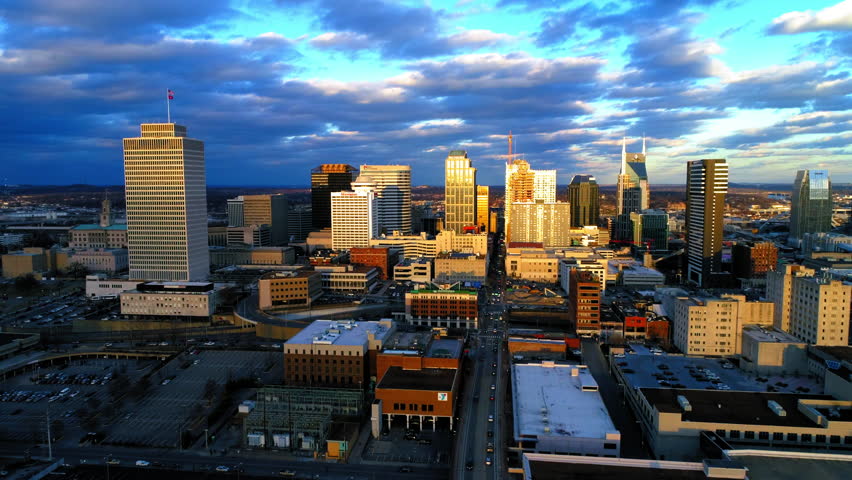 Aerial Slow Motion Shot Of Residential Buildings Under Cloudy Sky In City During Sunset - Nashville, Tennessee