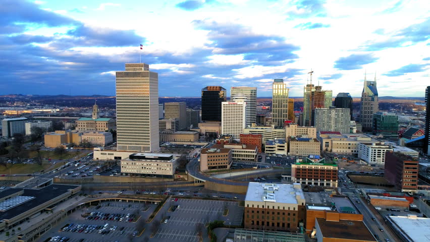 Aerial Forward Shot Of Skyscrapers By Vehicles Moving On Roads Under Cloudy Sky In Modern City - Nashville, Tennessee