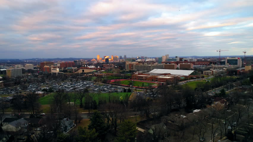 Aerial Backward Shot Of Residential Buildings With Cars Moving On Roads During Sunset In City - Nashville, Tennessee