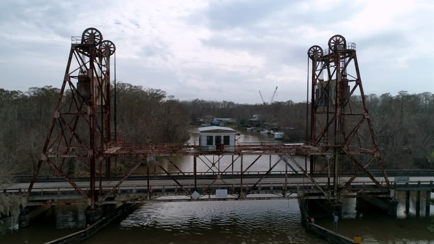 Aerial Shot Of West Pearl River Bridge Amidst Bare Trees, Drone Flying Forward Over River Under Clouds - New Orleans, Louisiana
