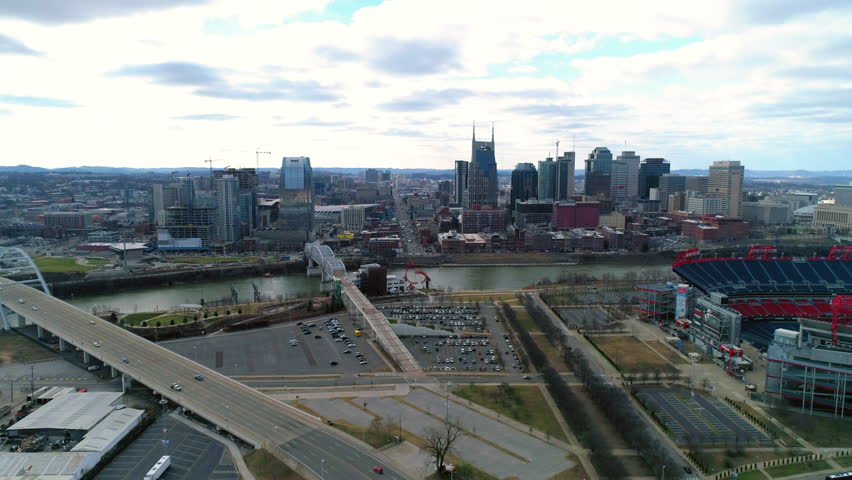 Aerial Panning Shot Of Cars Moving On Roads By Modern Buildings In Financial District - Nashville, Tennessee
