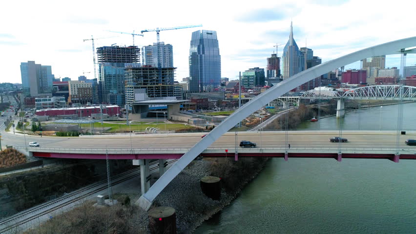 Aerial Lockdown Shot Of Skyscrapers By Cars Moving On Famous Bridge In Modern City - Nashville, Tennessee