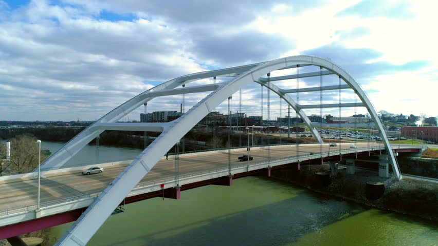 Aerial Forward Ascending Shot Of Korean Veterans Memorial Bridge Under Cloudy Sky In City - Nashville, Tennessee