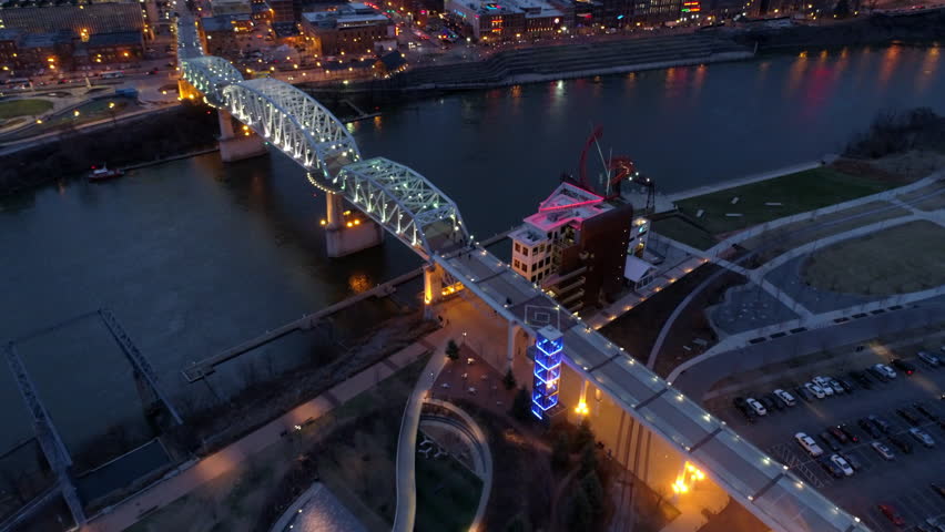 Aerial Tilt Up Shot Of Illuminated John Seigenthaler Pedestrian Bridge, Drone Flying Forward Over River In City - Nashville, Tennessee Royalty-Free Stock Footage #1102310793