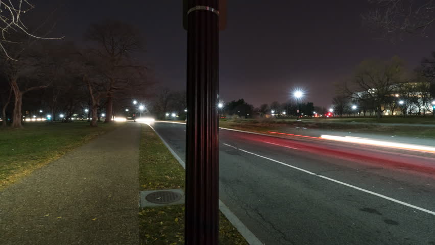 Panning Time Lapse Shot Of Illuminated Obelisk Shaped Building Against Clear Sky At Night - Washington, District of Columbia