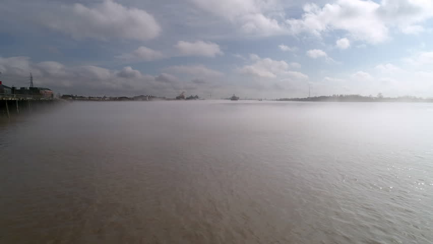 Aerial: Drone Forward Shot Of Smokey The Mississippi River Under Cloudy Sky - New Orleans, Louisiana