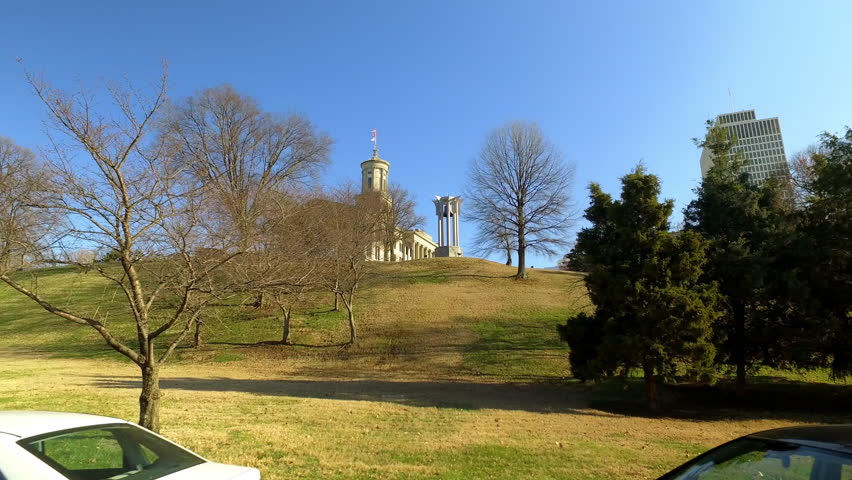 Point Of View Tennessee State Capitol By Modern Building In City Against Clear Sky On Sunny Day - Nashville, Tennessee